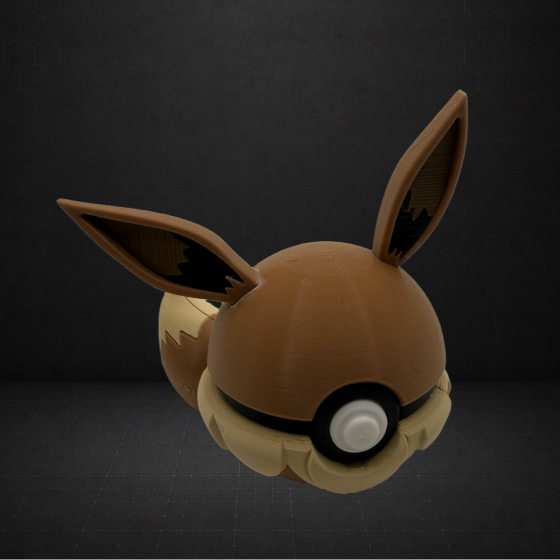A 3D-printed toy figure of a brown and beige fox-like Pokémon, resembling Eevee, shown against a dark gray background.